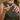 Person applying a white cream to their hand using a spray bottle.